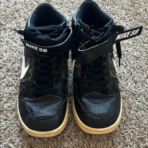 Nike Kids Black High-Top Sneakers with Camo Panels and White Swoosh